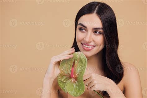 Beauty portrait of attractive young naked woman posing with flower