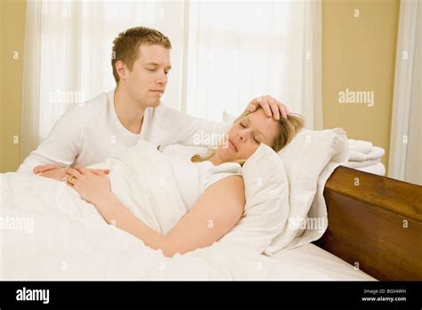 Loving husband caring for sick wife in bed Stock Photo, Royalty Free ...