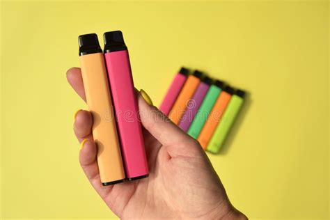 yellow disposable electronic cigarettes white background concept modern