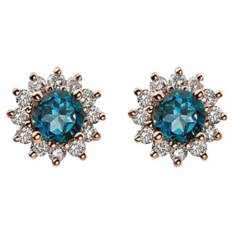 birthstone earrings featuring deep sea blue topaz nude diamonds