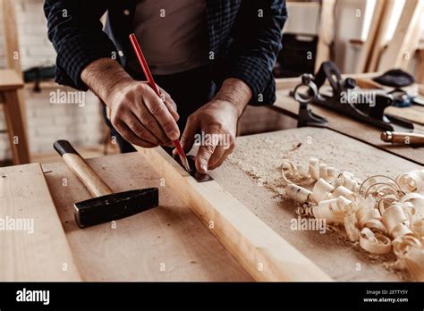 Carpenter makes pencil marks on a wood plank Stock Photo - Alamy