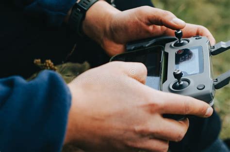 Man S Hands Holding the Remote Control of a Drone (Drone Operator ...