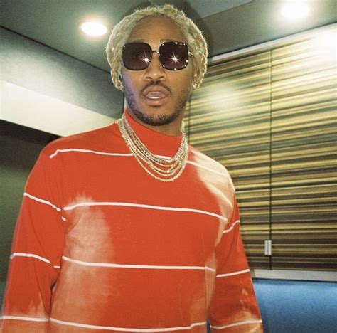 a man wearing sunglasses and a red striped shirt is standing in front ...
