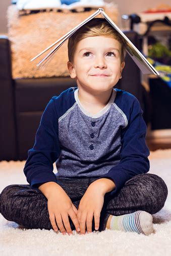 Happy Kid Holding A Book On His Head Stock Photo - Download Image Now - Balance, Book, Boredom ...