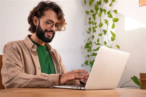 cheerful male writer working      laptop  home thinking