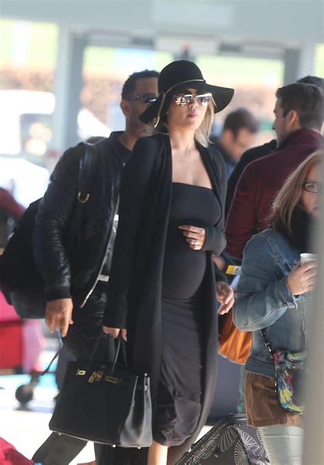 CHRISSY TEIGEN at Charles De Gaulle Airport in Paris 12/27/2015