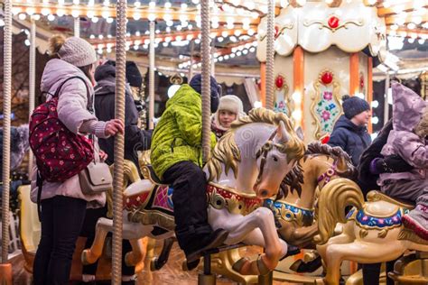 Children and Parents Spin on a Carousel. Winter Entertainment of ...