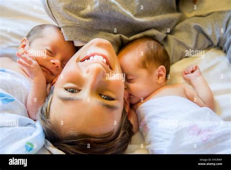 Big brother with twin baby sister and brother Stock Photo - Alamy