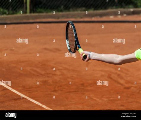 Human hand holding a tennis racket and preforming a forehand strike Stock Photo - Alamy