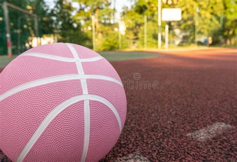 Pink Basketball Ball on the Ground. Close-up Ball on the Red Court ...