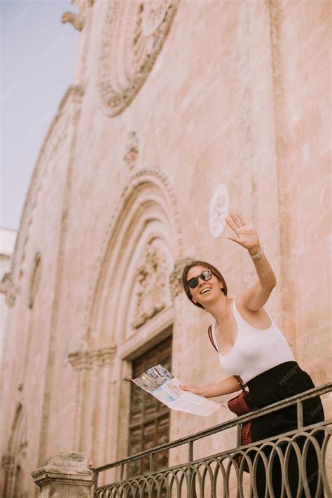 Premium Photo | Female tourist with a city map by the church san