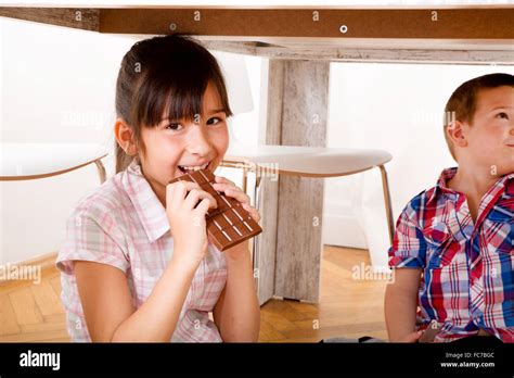 Kids eating chocolate at home Stock Photo - Alamy