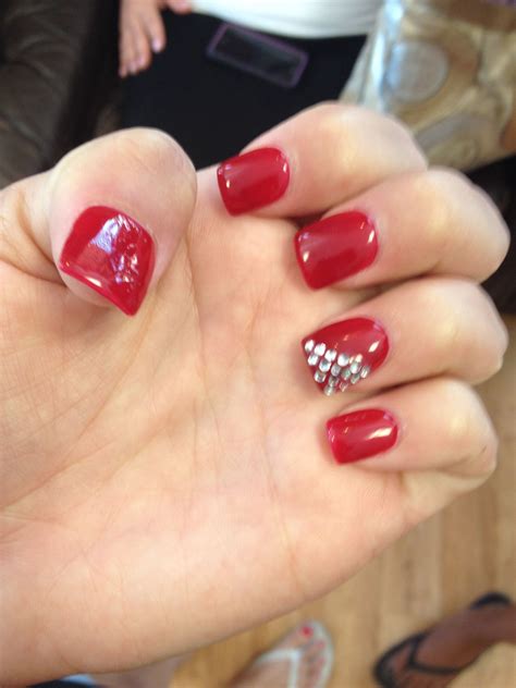 All red nails with rhinestones