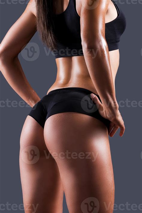 She got perfect buttocks. Rear view of beautiful young sporty woman
