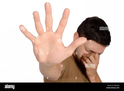 portrait   young sad man showing  hand stop sign isolated white