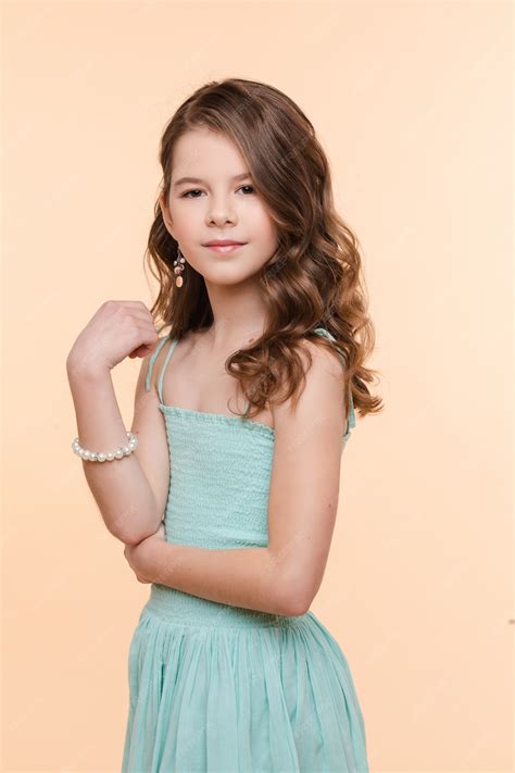 Premium Photo | Pre-teen girl with beautiful hair in blue dress.