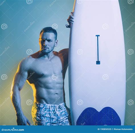 Muscular Male Body on Blue Background. Surfer Surfing Man with