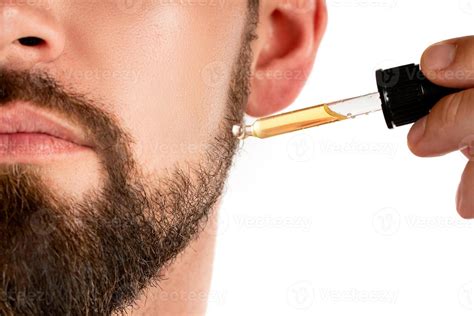 Male face and pipette with a oil for a beard growth 16293649 Stock ...