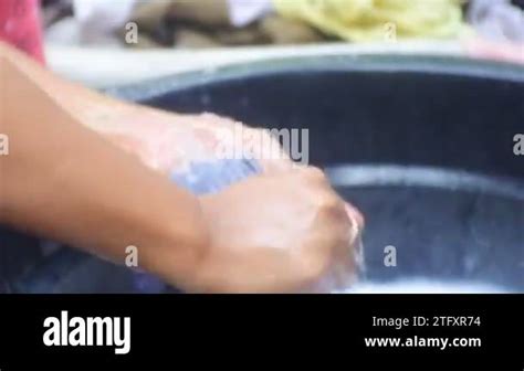asian woman washing clothes washing  scrubbing clothes close  hd