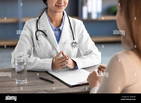 Happy young indian female doctor in white coat with stethoscope ...