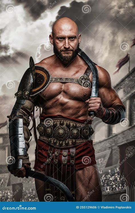 Roman Gladiator with Swords Posing in Ancient Coliseum Stock Photo 