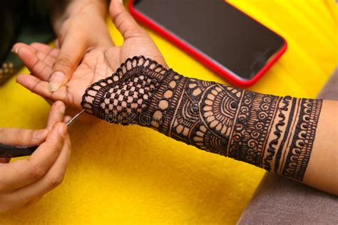 artist performing mehandi  henna design  female hand stock photo