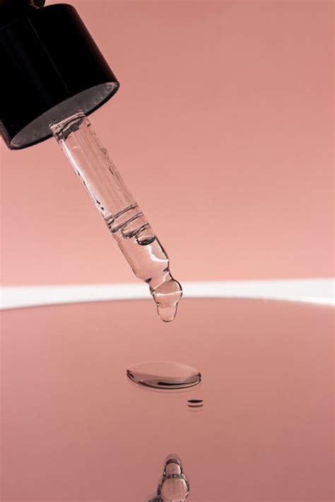 close   liquid dropper  reflection  stock photo