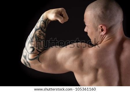 Strong Man With Relief Body And A Tattoo On His Arm Stock Photo ...