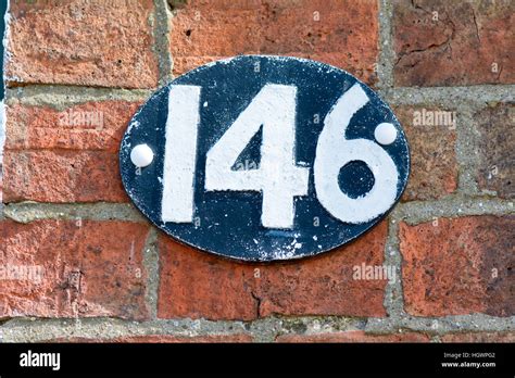House Number 146 sign on brick wall Stock Photo - Alamy