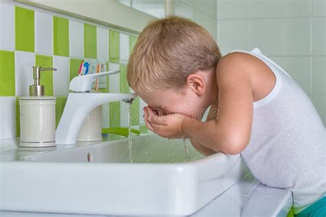 Boy Wash the Face in the Bathroom.the Beginning of a New Day Stock ...