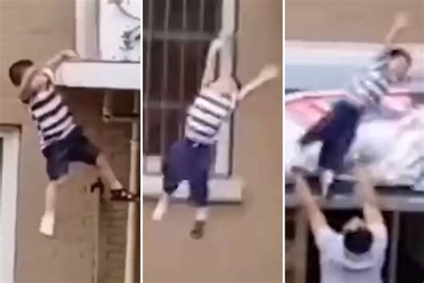 Heart stopping moment toddler is caught by neighbour after plunging 5 ...