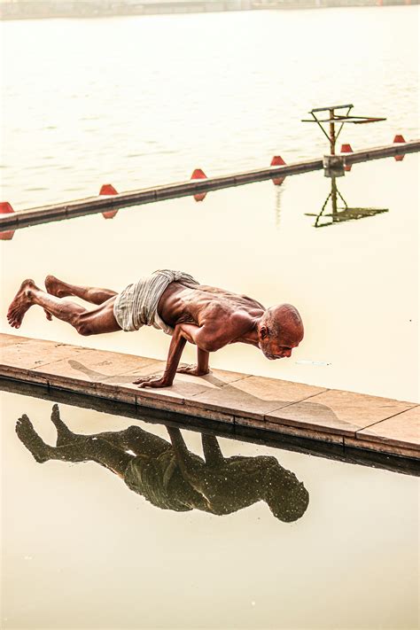 skinny shirtless man  handstand   boardwalk  stock photo