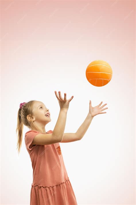 premium photo  cute happy girl throwing  ball