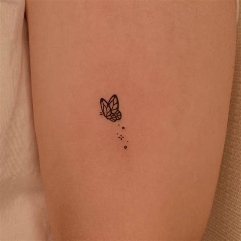 minimalist butterfly tattoo   upper arm