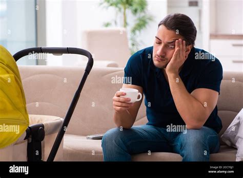 Young father looking after newborn baby Stock Photo - Alamy
