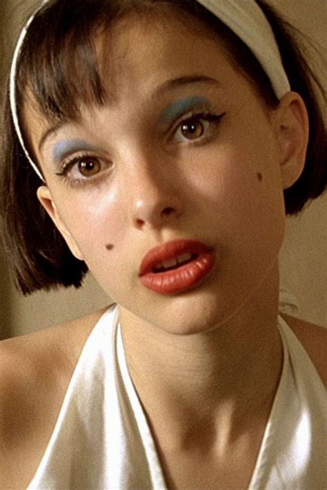 a woman with blue and red makeup is wearing a white halter top while ...