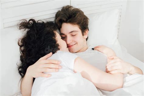 attractive couple sleeping cuddling bed stock