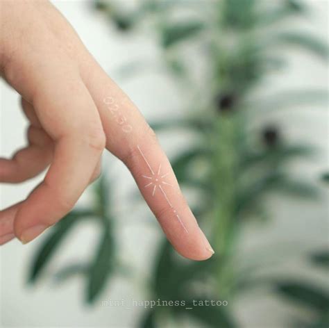 Minimalistic shooting star tattoo in white ink located