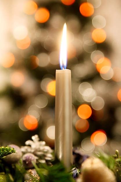 Premium Photo | One advent candle with christmas tree at background