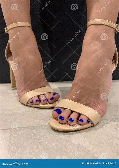Woman Standing Indoors in Nude Beige High Heel Sandals Stock Image