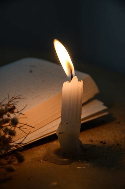 Open Book among Scented Candles · Free Stock Photo