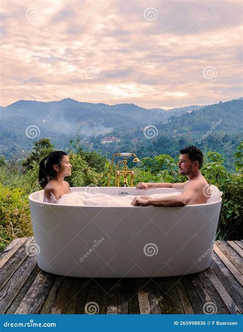 A Couple of Men and Women in a Bath Tub in the Evening during Sunset