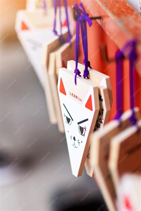 Premium Photo | Fox shape ema wooden wishing plaques in fushimi inari