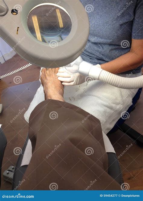 PODIATRIST WORKING on FOOT stock image. Image of news - 59454277
