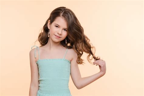 Premium Photo | Pre-teen girl with beautiful hair in blue dress.