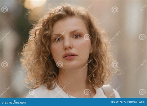 A Headshot Photo of a Woman with Curly Hair in an Old European Town ...