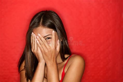 playful shy woman hiding face laughing stock photo image  happy