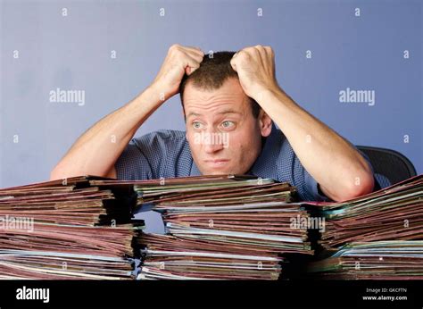 man pulling  hair  stressed  work  piles  files  front