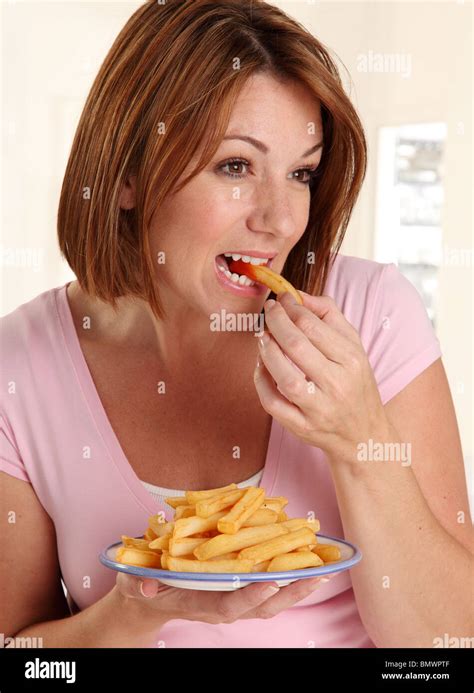 WOMAN EATING FRENCH FRIES Stock Photo - Alamy