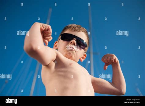 healthy preschool child showing his biceps outdoors summer Stock Photo ...